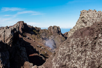 Panoramic view on the edge of the active volcano crater of Mount Vesuvius, Province of Naples, Campania region, Southern Italy, Europe, EU. Volcanic landscape full of stones, ashes and solidified lava