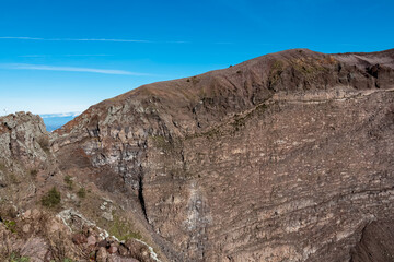 Panoramic view on the edge of the active volcano crater of Mount Vesuvius, Province of Naples, Campania region, Southern Italy, Europe, EU. Volcanic landscape full of stones, ashes and solidified lava