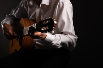 Classical guitar  up close on a black background with copy space