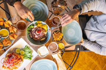 Table of a restaurant with people eating peruvian dishes