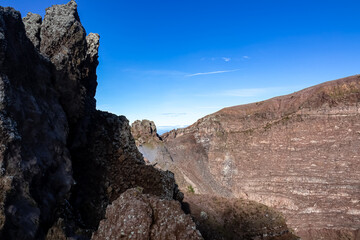 Panoramic view on the edge of the active volcano crater of Mount Vesuvius, Province of Naples, Campania region, Southern Italy, Europe, EU. Volcanic landscape full of stones, ashes and solidified lava