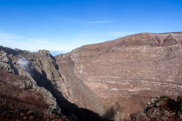 Panoramic view on the edge of the active volcano crater of Mount Vesuvius, Province of Naples, Campania region, Southern Italy, Europe, EU. Volcanic landscape full of stones, ashes and solidified lava