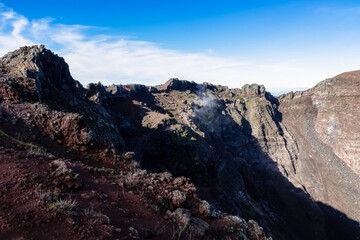 Panoramic view on the edge of the active volcano crater of Mount Vesuvius, Province of Naples, Campania region, Southern Italy, Europe, EU. Volcanic landscape full of stones, ashes and solidified lava