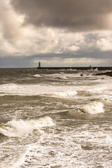 Looking across King Edwards Bay at the rough seas on a cloudy day at Tynemouth, England