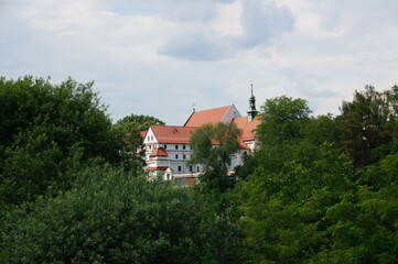 Fototapeta na wymiar Franciscan monastery in the distance among the greenery. Wieliczka, Poland.