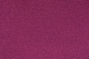The texture of the fabric is purple, burgundy. Background made of red material with small straight...