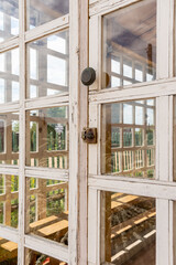 The wooden glazed frame is painted white on the summer veranda.