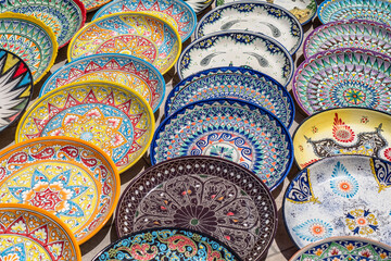 Decorative ceramic plates with traditional uzbek ornament in the street market of Bukhara. Uzbekistan