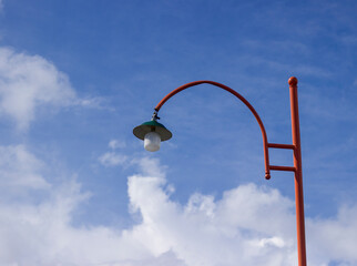 red lamppost against the background of a clear sky in the garden