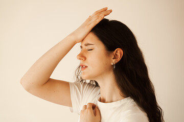 Migraine is a strong headache of woman. Overstressed woman touches her head because of pain....