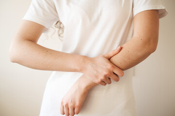 Hand injury. Beautiful girl with pain and bruise in her arm due to an accident. Traumatology.