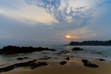 Fototapeta na wymiar Low tide on the ocean during sunset