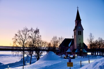 Fototapeta na wymiar Beautiful pink Old church in Arjeplog in winter, very peri background