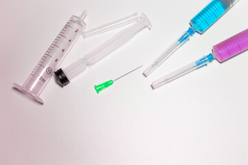 Few medical syringes with the needles - pharmaceutical composition. Space for text. Pharmaceutical images with copy space.