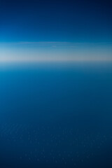 Aerial view of wind turbines of an offshore wind farm in the sea. 