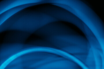 Blur glow overlay. Neon light flare. Futuristic texture glare. Defocused navy blue color curve rays reflection on dark black modern abstract background.