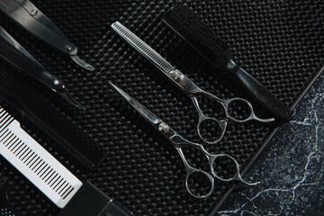 Professional scissors on black background. Hairdressing industry. Professional hairdressing tools