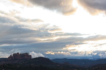 White storm clouds in a blue sky over the Red Rocks of Sedona, Arizona.