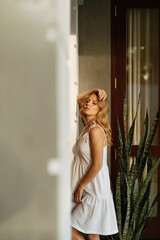 Beautiful slender woman blonde in a white dress near the house in Galle Fort Sri Lanka