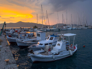 Beautiful sunset in the harbor on a sailing catamaran boat. sailing vessel boat anchored in the marina in Greece. Kalamos Meganisis Marina. Vathi Marina Port. Go Everywhere