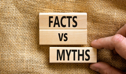 Facts vs myths symbol. Concept words Facts vs myths on wooden blocks on a beautiful canvas table canvas background. Businessman hand. Business, finacial and facts vs myths concept. Copy space. - obrazy, fototapety, plakaty