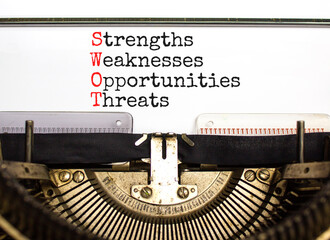 SWOT strengths weaknesses opportunities symbol. Concept words SWOT strengths weaknesses opportunities typed on beautiful old retro typewriter. Business SWOT strengths weaknesses opportunities concept.