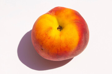 a fresh juicy peach lies on a white background