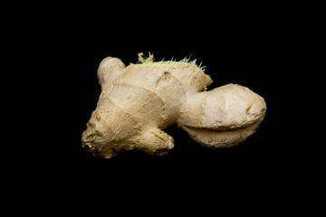 ginger root lies on a black background