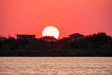 The sun goes down over a lake