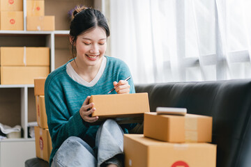 Portrait of a small business startup, SME owner, female entrepreneur, working, unboxing, checking...