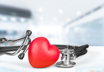 Red heart shape hand exercise ball with doctor physician's stethoscope. World heart health day....