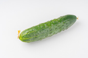 fresh green cucumber with pimples on a white background, the concept of healthy food and non-gmo products, selective focusing, macro photos from different angles, reflection on white
