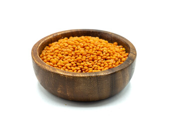 red lentils pulses in wooden bowl isolated on white background