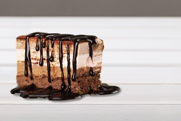 Sweet pieces of delicious chocolate brownie on background