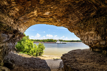 An Ohio River barge is viewed from Cave-In-Rock, a natural cavern and main attraction of its namesake Illinois state park. The cave, in a limestone bluff, is said to have been a pirates’ hideout.