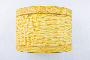 Wooden round carved box on a white background. Wooden box with a place
