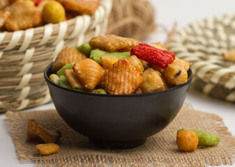 thailand rice crackers served in a bowl isolated on napkin side view of nuts on grey background