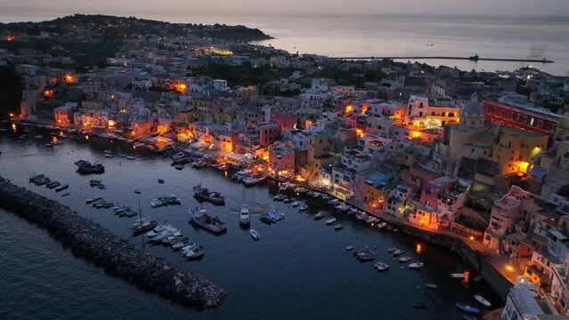 island of Procida at night near Naples in the Mediterranean Sea, aerial view of Italian historical fishermen village on Procida in the evening