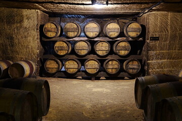 Saint Emilion / France - August 2018 : Traditional wine cellar in Saint Emilion with barrels.