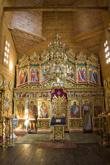 Fototapeta na wymiar Interior of wooden Church of the Protection of the Most Holy Theotokos in Cossack village (museum) Mamaeva Sloboda in Kyiv, Ukraine