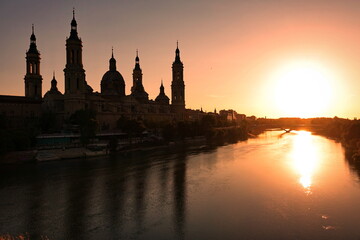 Fototapeta na wymiar The Cathedral-Basilica of Our Lady of the Pillar and Ebor River at Sunset