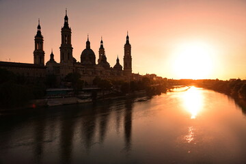 Fototapeta na wymiar The Cathedral-Basilica of Our Lady of the Pillar and Ebor River at Sunset