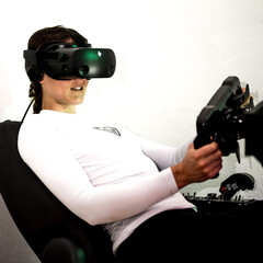 A gamer woman is sim racing with a high end simracing reck