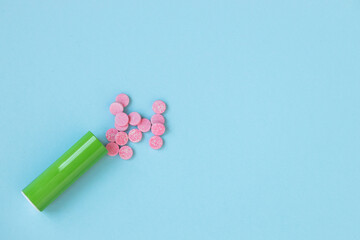 Pink pills isolated on blue background