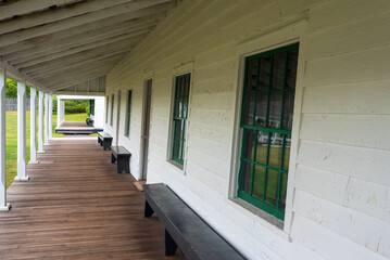 Bench on the covered porch and buildings at the Fort Wilkins Historic State Park