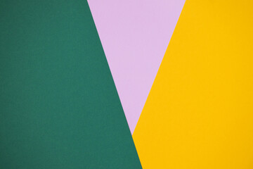 multicolor paper background in pink, green and yellow