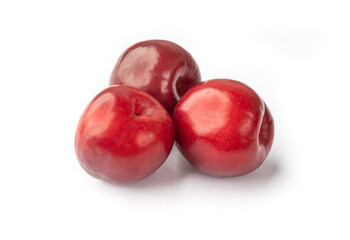 Fototapeta na wymiar A group of red plums isolated over white background