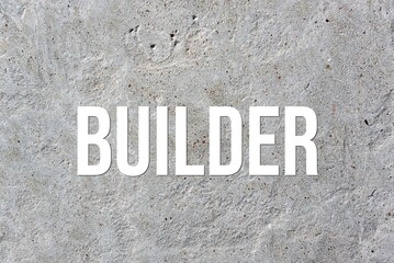 BUILDER - word on concrete background. Cement floor, wall.