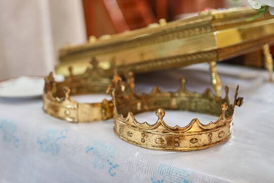 During the wedding ceremony, golden crowns are placed on the church throne.