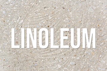 LINOLEUM - word on concrete background. Cement floor, wall.